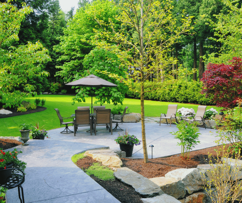 Beautiful backyard scene with patio furniture, trees providing shade while letting adequate sunshine through.